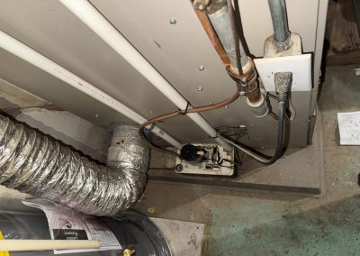 Condensate pump and plumbing connected to a furnace unit.