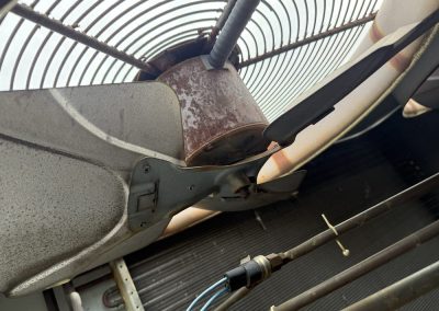 Close-up of a rusted outdoor HVAC fan and motor.