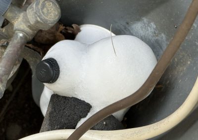 Heavy ice buildup on an air conditioner coolant line.