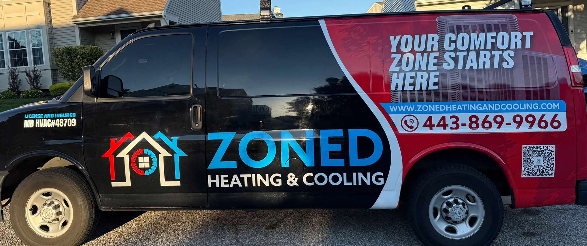 A Zoned Heating & Cooling van with company logo, website, phone number, and slogan displayed on the side.