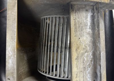 Dirty metal HVAC blower wheel assembly.