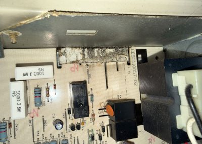 HVAC control board with burnt components near a connector